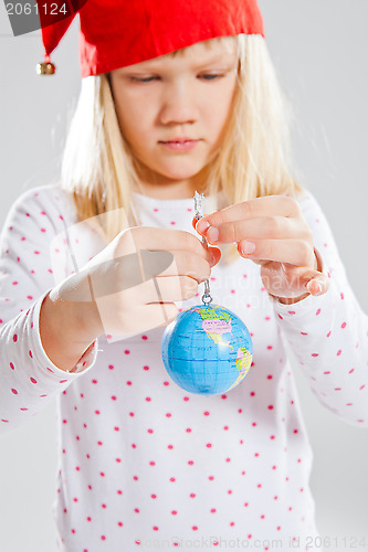 Image of Young girl holding world in hands