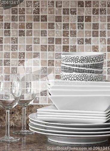 Image of White dishes and plates on kitchen countertop