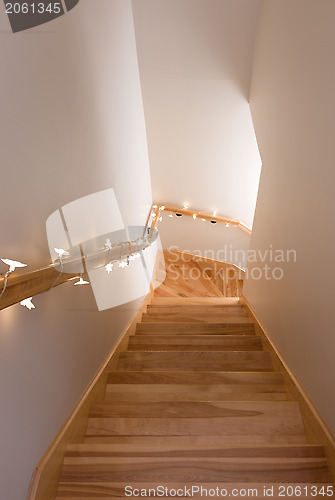 Image of Wooden staircase decorated with lights