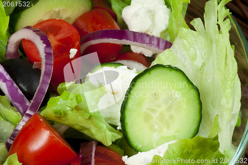 Image of Salad in a glass bowl close up. 