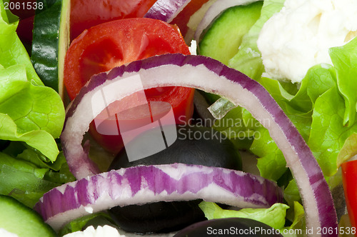 Image of Salad in a glass bowl close up. 