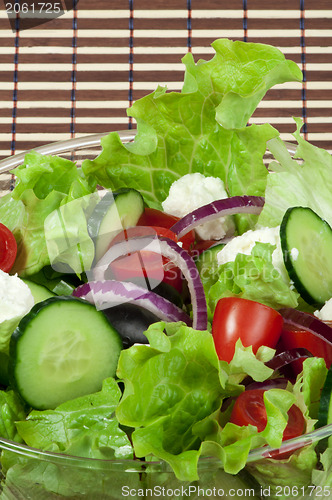 Image of Salad in a glass bowl close up. 