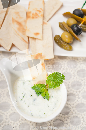 Image of Greek Tzatziki yogurt dip and pita bread