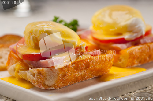 Image of eggs benedict on bread with tomato and ham