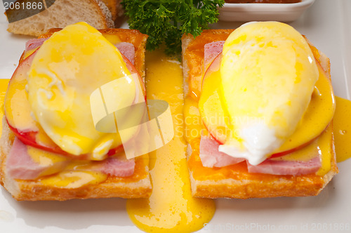 Image of eggs benedict on bread with tomato and ham