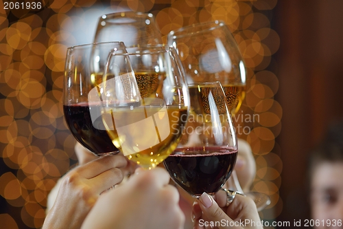 Image of Hands holding the glasses of champagne and wine