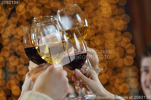 Image of Hands holding the glasses of champagne and wine