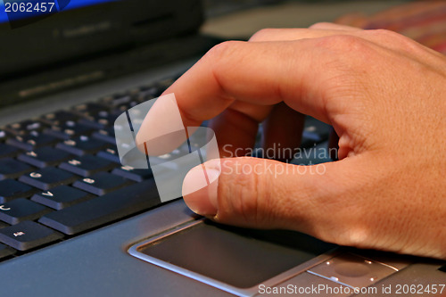 Image of Hand on notebook keyboard