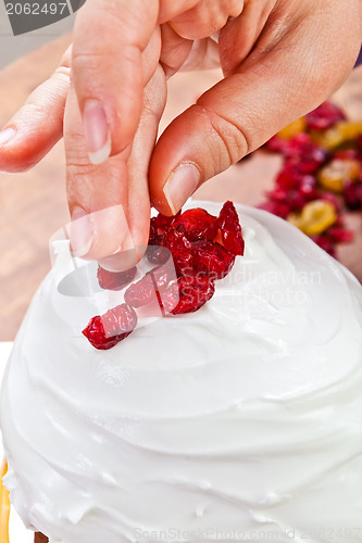 Image of Hands decorating christmas cake