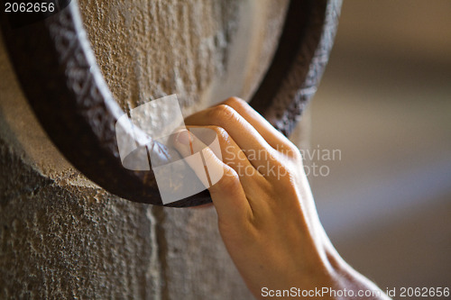 Image of Woman knocking on a clapper