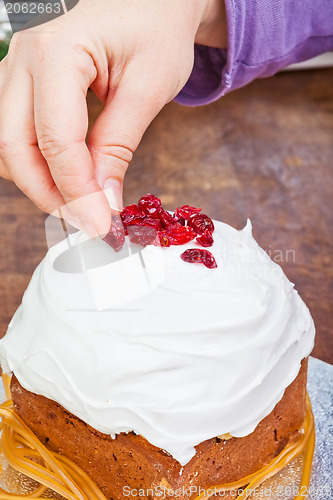 Image of Hands decorating christmas cake
