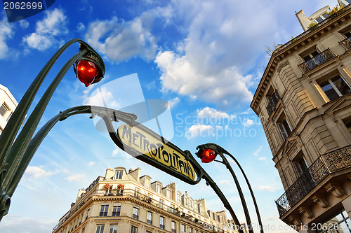 Image of Paris. Underground Metro sign with buildings and sunset colors