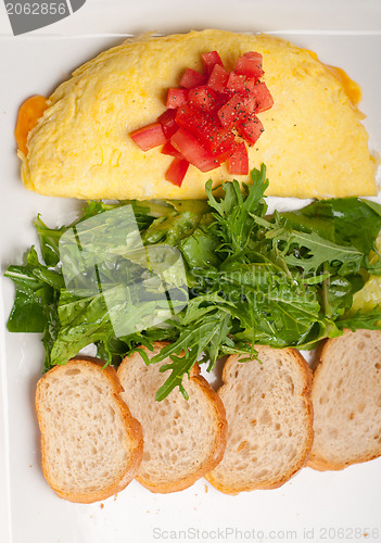Image of cheese ometette with tomato and salad
