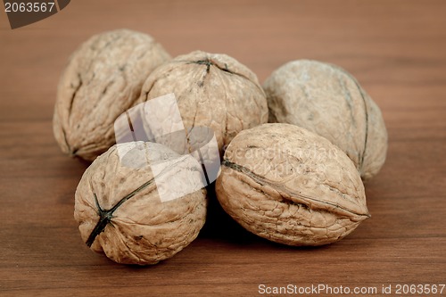 Image of walnuts on wooden background