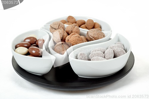 Image of almonds in chocolate and walnuts on white