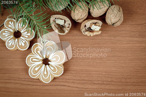 Image of walnuts and gingerbread on wooden background