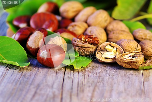 Image of  chestnuts and walnuts on wooden table