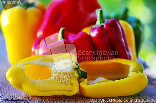 Image of red, yellow and green pepper on table