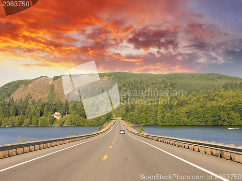 Image of Beautiful road on the lake with sunset colors