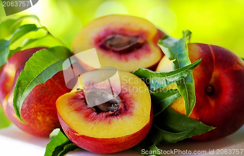 Image of Sliced peachs on green background