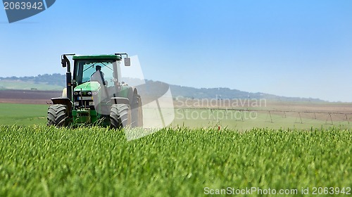 Image of Green tractor working . 