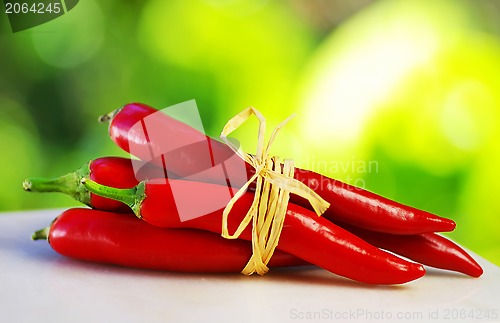 Image of Red hot chili peppers tied with rope