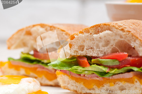 Image of ciabatta panini sandwich eggs tomato lettuce