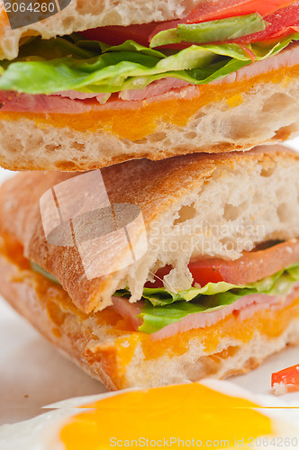 Image of ciabatta panini sandwich eggs tomato lettuce