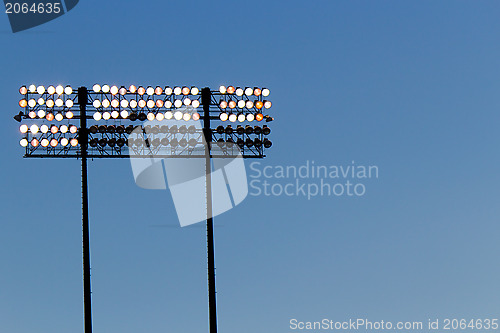 Image of Stadium lights over a blue sky