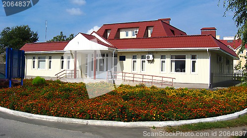 Image of view on establishment with bed of flowers