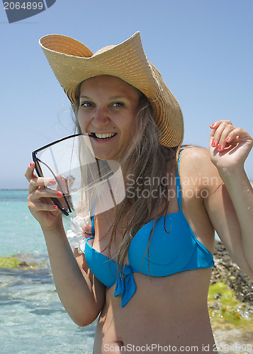 Image of Azure sea and young woman in traw hat                      