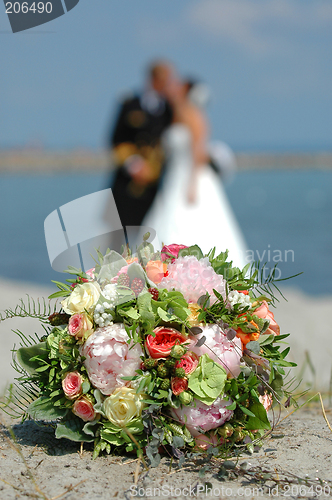 Image of bouquet, bride and groom