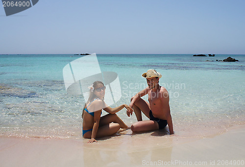 Image of Young happy couple on the beach