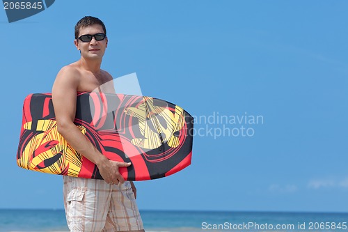 Image of young man with boogie board