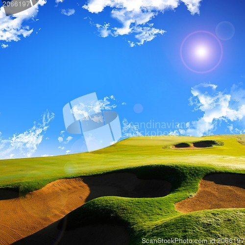 Image of A photo of a blue sky and a green field 