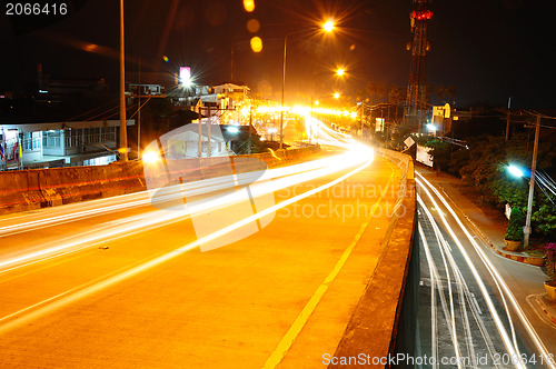 Image of highway bridge at night with traces of light traffic 