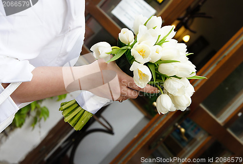 Image of Wedding bouquet of white tulips in the bride?s hand 