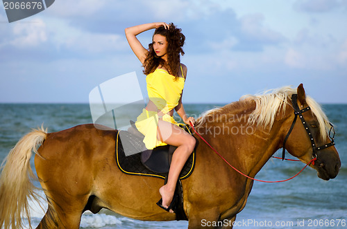 Image of Young woman riding a horse