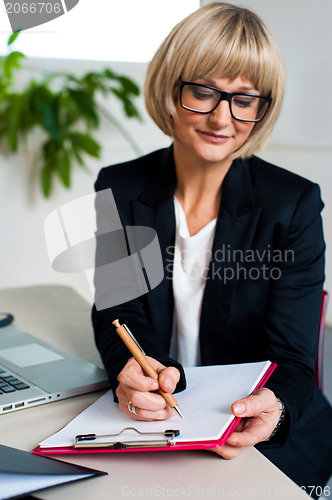 Image of Secretary jotting down notes and instructions