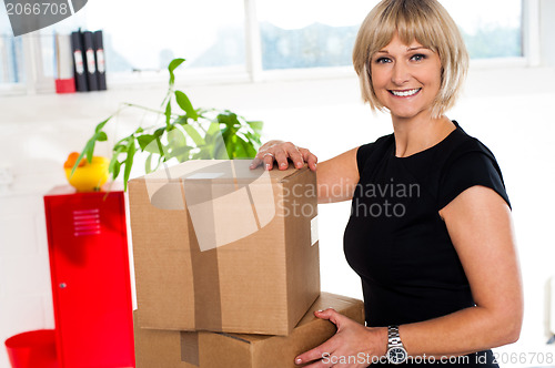 Image of Blonde woman is ready to unpack her office stuff