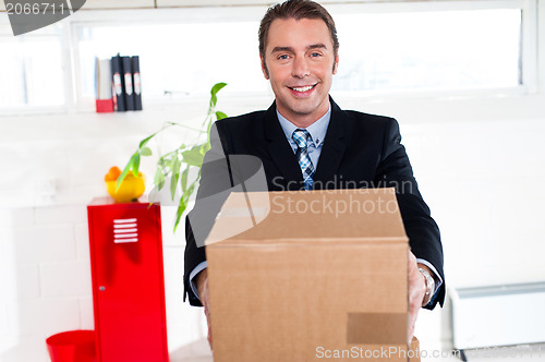 Image of Active executive carrying packed carton