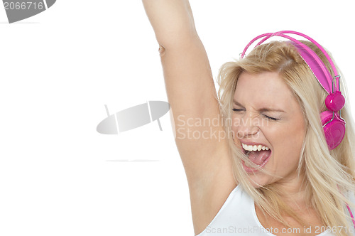 Image of Woman enjoying loud music. Rock on