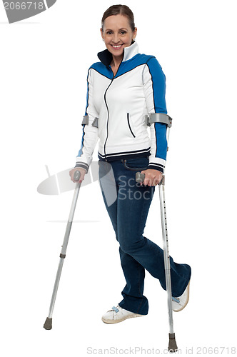 Image of Woman walking with the support of crutches