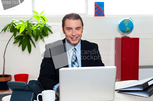 Image of Corporate leader sitting in front of his laptop