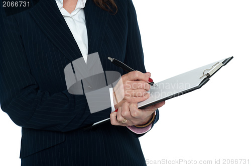 Image of Cropped image of female secretary taking notes