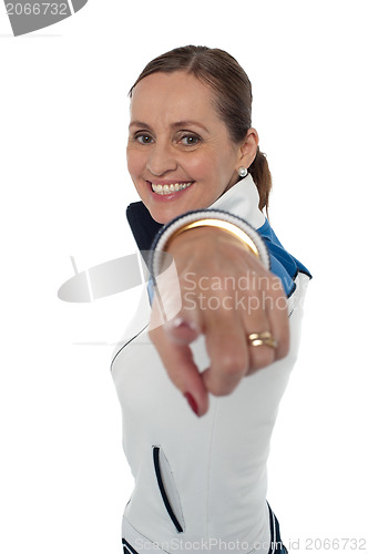 Image of Cheerful woman standing sideways and pointing at you
