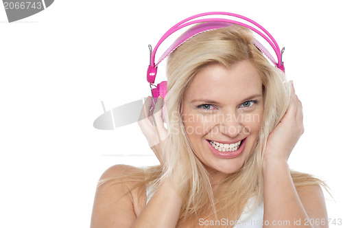 Image of Hot blonde listening to music via headphones