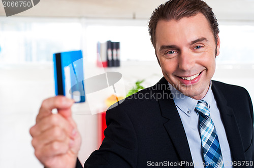 Image of Handsome male executive holding cash card