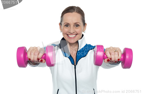 Image of Female working out with pink dumbbells