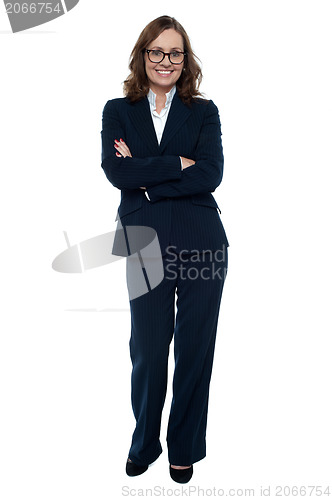 Image of Executive in business attire standing arms folded